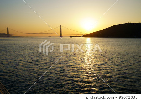 Sunrise over the Akashi Kaikyo Bridge seen from the ferry Sunrise over the Akashi Kaikyo Bridge seen from the ferry 99672033