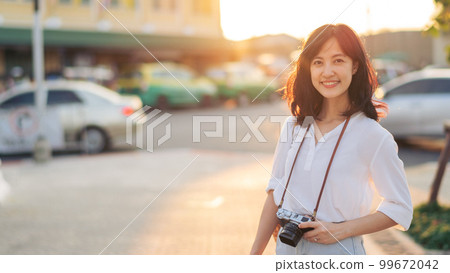 Portrait of asian woman traveler using camera at street of Bangkok, Thailand. Asia summer tourism vacation concept Portrait of asian woman traveler using camera at street of Bangkok, Thailand. Asia summer tourism vacation concept 99672042