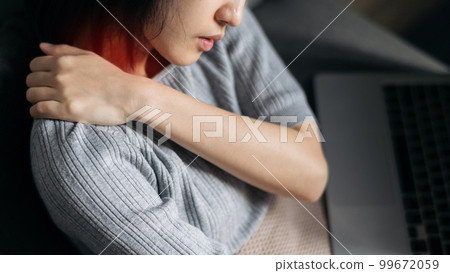 Asian woman has shoulder pain. Female holding painful shoulder with another hand. People with body-muscles problem, Healthcare And Medicine. Asian woman has shoulder pain. Female holding painful shoulder with another hand. People with body-muscles problem, Healthcare And Medicine. 99672059