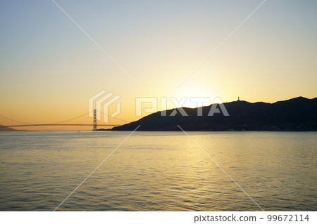 Sunrise over the Akashi Kaikyo Bridge seen from the ferry Sunrise over the Akashi Kaikyo Bridge seen from the ferry 99672114