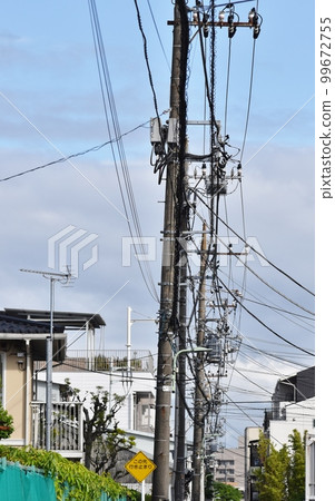 Various cables and wires and utility poles that support them Various cables and wires and utility poles that support them 99672755