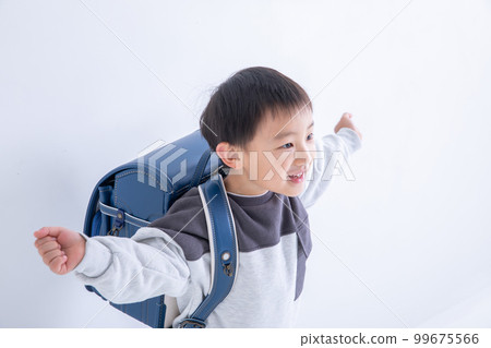 First grader carrying a school bag First grader carrying a school bag 99675566