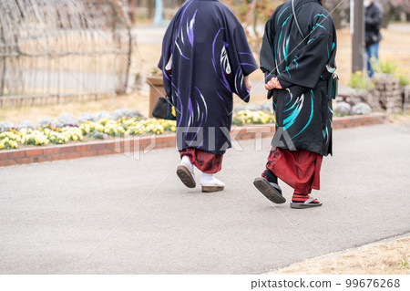 An elderly couple wearing antique kimono strolling through the Saburi Pond plum grove where the Saburi plums have begun to bloom. An elderly couple wearing antique kimono strolling through the Saburi Pond plum grove where the Saburi plums have begun to bloom. 99676268