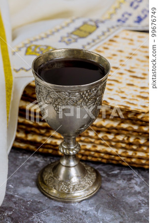 Cup of kosher kiddush wine is served with kosher matzah bread during Passover. 99676749