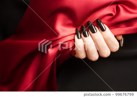 Hands of a young girl with black  manicure on nails 99676799