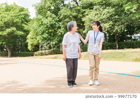 Elderly people exercising, walking, and walking in the park and women who are caregivers, nurses, physical therapists, and exercise instructors 99677170