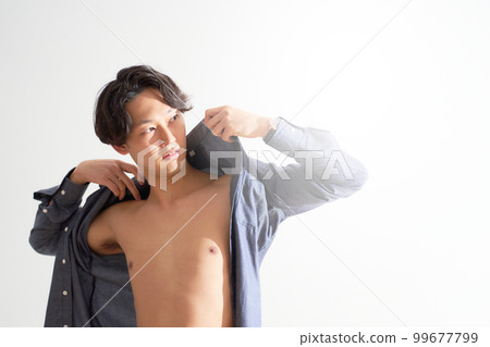 A young man wearing a shirt in a sunny room Men's beauty lifestyle image A young man wearing a shirt in a sunny room Men's beauty lifestyle image 99677799
