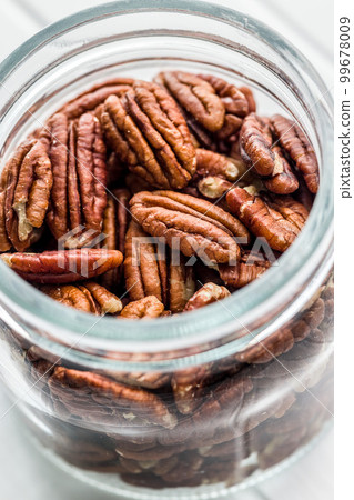 Peeled pecan nuts in jar. Peeled pecan nuts in jar. 99678009
