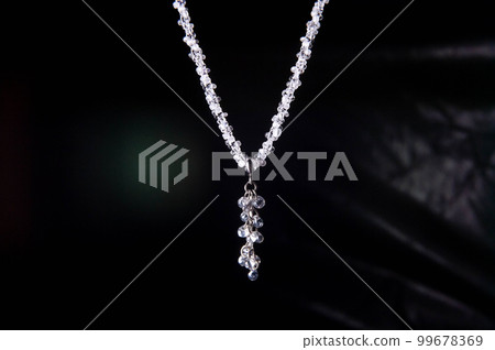 Beading, white beaded beads on a black background, handmade decoration with a bandage 99678369