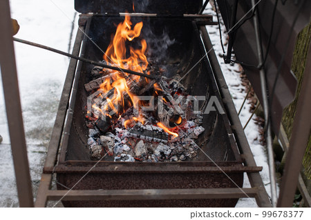 Kindling a fire in the brazier, burning coals 99678377