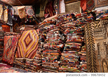 Colorful, oriental carpets at a carpet dealer in Goreme, Cappadocia, Turkey 99678432