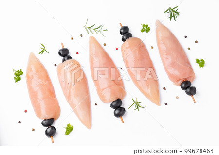 Skewers of raw meat and vegetables.Top view.Chicken Skewers breast fillet meat.Raw chicken inner on skewers with olives with spices,herbs on white background.Uncooked Chicken meat,kebab on skewers. Skewers of raw meat and vegetables.Top view.Chicken Skewers breast fillet meat.Raw chicken inner on skewers with olives with spices,herbs on white background.Uncooked Chicken meat,kebab on skewers. 99678463