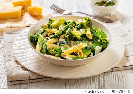 Pasta primavera with green veggies, cheese in bowl 99678708