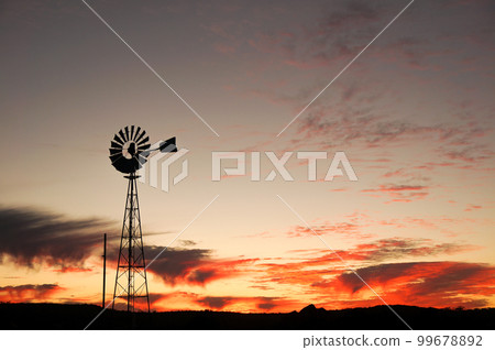 Silhouette of a windmill in the Australian wilderness Silhouette of a windmill in the Australian wilderness 99678892