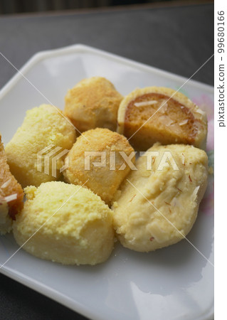 close up of indian sweet in a bowl on table. 99680166