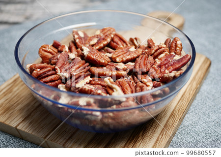 Tasty pecan-nut in a bowl on table Tasty pecan-nut in a bowl on table 99680557