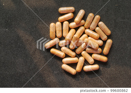 top view of herbal medicine capsule dropping on white top view of herbal medicine capsule dropping on white 99680862