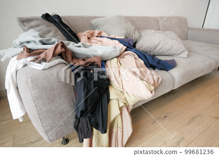 Messy clothes on sofa at home Messy clothes on sofa at home 99681236