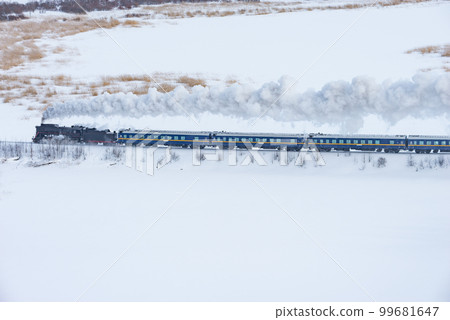 Retro steam train moves at winter day. Retro steam train moves at winter day. 99681647