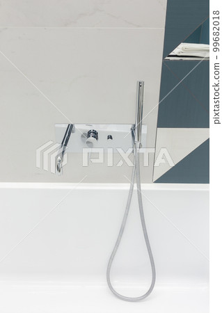 Ultra modern bathroom in stark white with silver faucet. 99682018