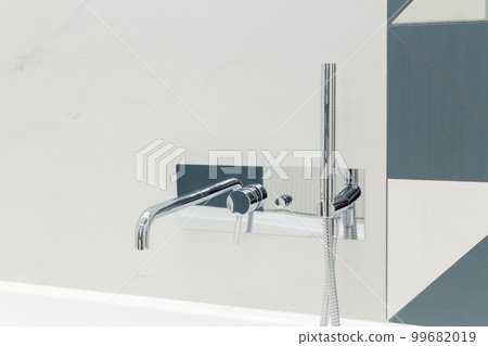 Ultra modern bathroom in stark white with silver faucet. 99682019