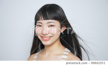 Woman with black hair blowing in the wind Hair care image slow motion 99682051