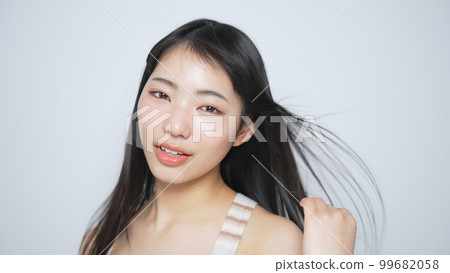 Woman with black hair blowing in the wind Hair care image slow motion 99682058