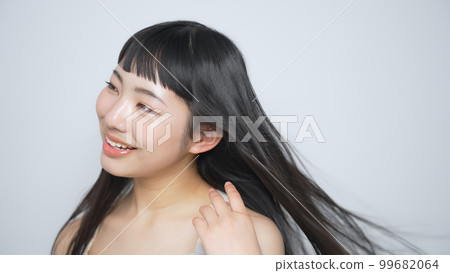 Woman with black hair blowing in the wind Hair care image Woman with black hair blowing in the wind Hair care image 99682064