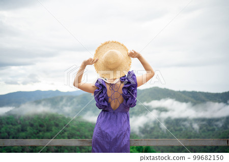 Carefree happy woman in morning of nature cliff mountain. Woman travel tourist alone morning freedom and happiness Carefree happy woman in morning of nature cliff mountain. Woman travel tourist alone morning freedom and happiness 99682150