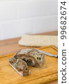 Moldy bread on a cutting board. Close-up view. Selective focus. Copy space. 99682674