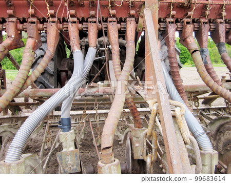 Plowed field by tractor in brown soil on open countryside nature 99683614