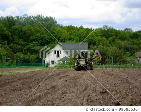 Plowed field by tractor in brown soil on open countryside nature 99683630