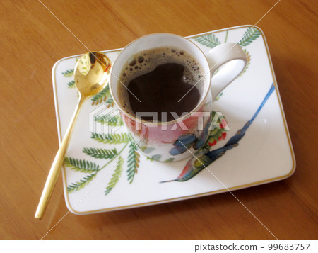 Beauty coffeecup standing on wooden table with dark tasty coffee Beauty coffeecup standing on wooden table with dark tasty coffee 99683757