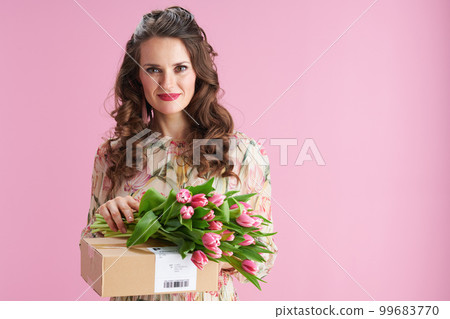 modern woman with long wavy brunette hair on pink modern woman with long wavy brunette hair on pink 99683770