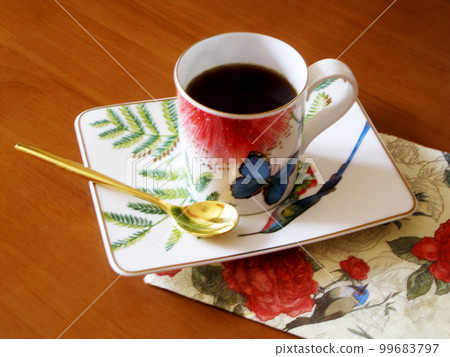 Beauty coffeecup standing on wooden table with dark tasty coffee Beauty coffeecup standing on wooden table with dark tasty coffee 99683797