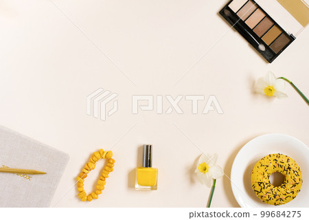 Flat lay fashion blogger with copy space. Cosmetics, donut, notepad with pen for notes and notes Flat lay fashion blogger with copy space. Cosmetics, donut, notepad with pen for notes and notes 99684275