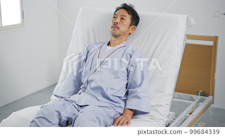 Man sleeping on an electric reclining bed Man sleeping on an electric reclining bed 99684339