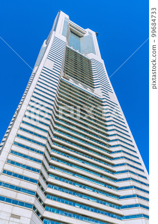 A popular spot in front of Sakuragicho Station, the cityscape of Yokohama in Japan. Yokohama Landmark Tower against the blue sky 99684733