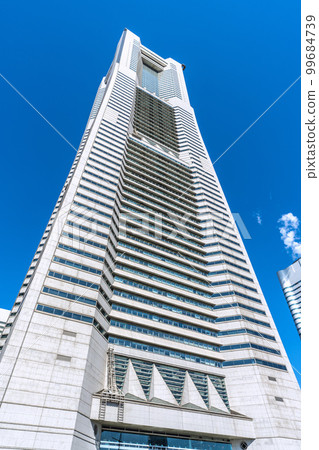 A popular spot in front of Sakuragicho Station, the cityscape of Yokohama in Japan. Yokohama Landmark Tower against the blue sky 99684739