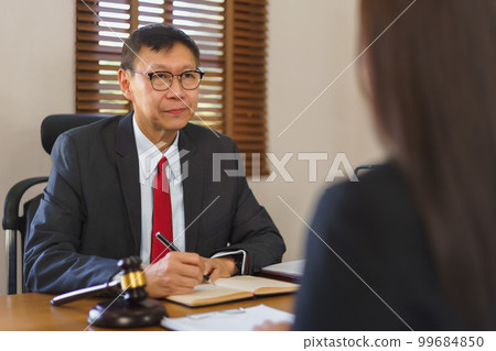 Legislation and justice concept, Young female lawyer discussing law of contract with senior lawyer Legislation and justice concept, Young female lawyer discussing law of contract with senior lawyer 99684850
