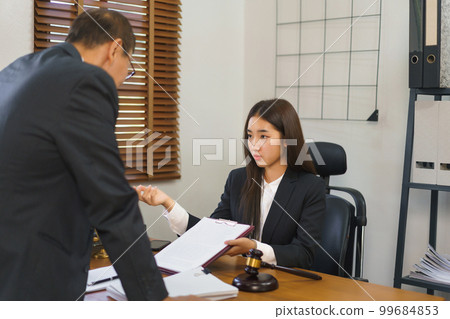 Legal and justice concept, Female lawyer shows contract to explains and consults with senior lawyer 99684853