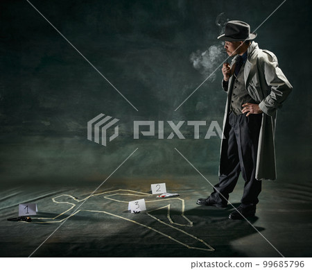 Portrait of man, detective in trench coat standing near human drawn silhouette on floor and smoking pipe over vintage dark green background 99685796