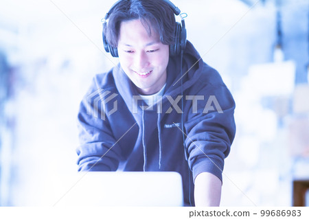 Man enjoying music mixing on computer 99686983