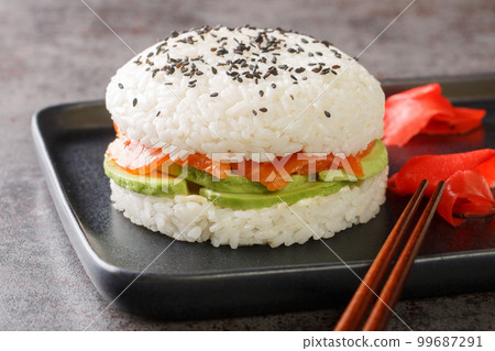 Homemade asian style gluten free sushi salmon burger close-up on a plate. Horizontal 99687291