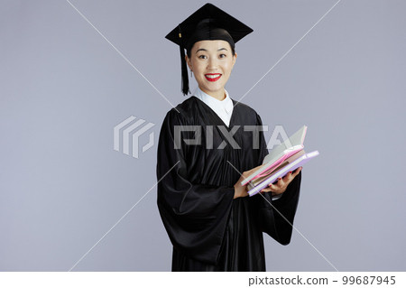 happy graduate student asian woman against gray 99687945