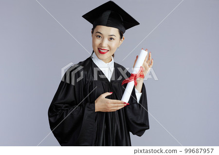 happy graduate student asian woman against grey 99687957