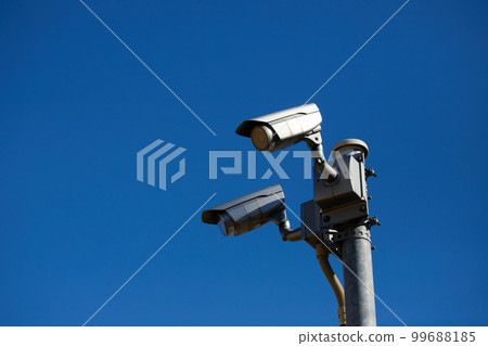 Landscape of surveillance camera on electric pole with blue sky Landscape of surveillance camera on electric pole with blue sky 99688185