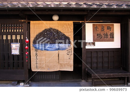 An old folk house with impressive noren curtains and scapegoats 99689973