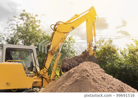 A bulldozer excavator is digging on outdoors in an industrial site. Excavation A bulldozer excavator is digging on outdoors in an industrial site. Excavation 99691516