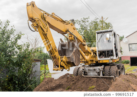 Bucket and hydraulic piston excavator or bulldozer close-up in industrial zone Bucket and hydraulic piston excavator or bulldozer close-up in industrial zone 99691517